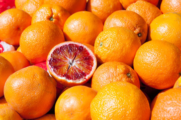 Blood oranges on market stand as background