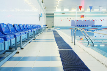 Blue chairs at the swimming pool