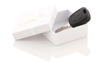 the key to the car in a white gift box on a white background