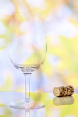 Empty red wine glass and wine bottle cork