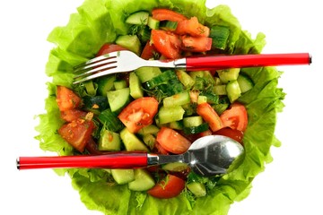 Salad of tomatoes, cucumbers and dill on lettuce leaves