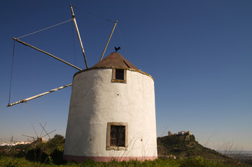 Fototapeta na wymiar Windmill against Palmela castle