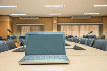 Before a conference,Laptop in front of empty chairs at conferenc