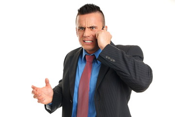 Angry young man in suit talks into mobile phone