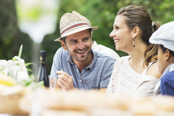 Three people on a garden party