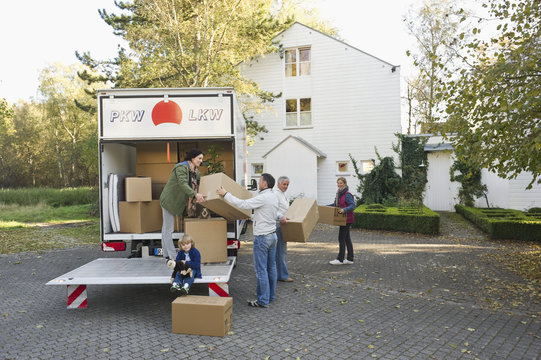 Germany, Bavaria, Grobenzell, Family loading boxes into truck for moving house