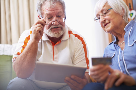 Senior couple shopping online at home