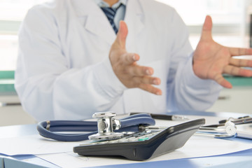 Close-up of stethoscope on background of doctors at work
