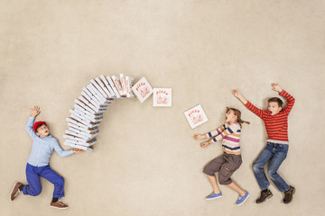 Boy delivering stack of pizzas