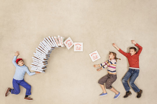 Boy delivering stack of pizzas