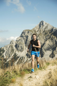 Austria, Tyrol, Tannheim Valley, young man jogging in mountains