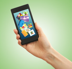 Hand holding mobile phone with different pictures