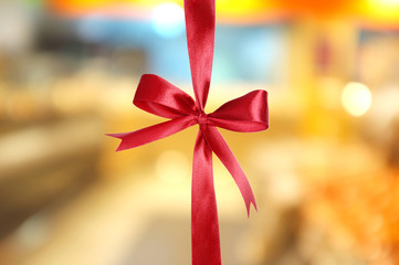 Color satin ribbon bow on bright background