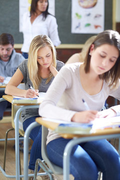 Students in classroom having an exam