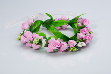 tiara of artificial  roses on a light background