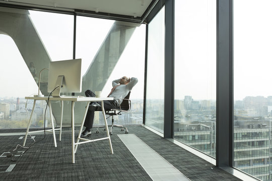 Businessman leaning back in new office