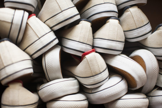 Pile of white canvas shoes