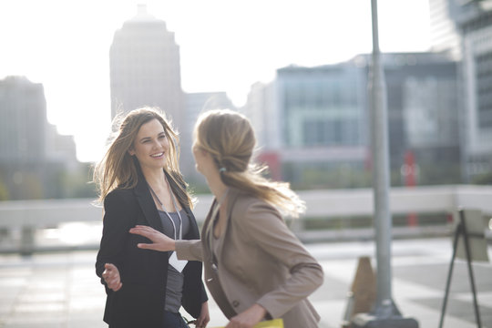 Businesswoman saying good bye to her colleague