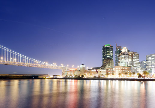 USA, California, San Francisco, Oakland Bay Bridge and Rincon Park at night