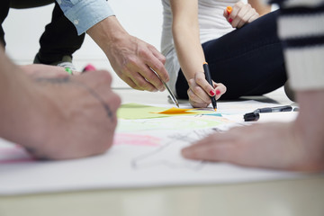 Creative professionals drawing on paper