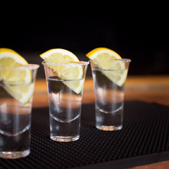 Three tequila shots with lemon