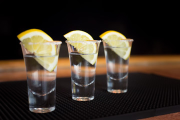 Three tequila shots with lemon