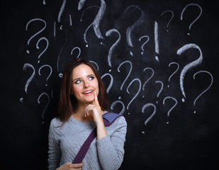 Young girl with question mark on a gray background