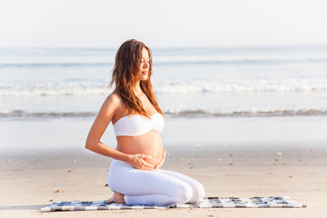 Fototapeta na wymiar Pregnant woman in a breathing Pose - Pilates Yoga