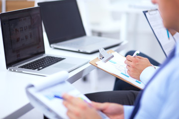Business people sitting and writting at business meeting, in