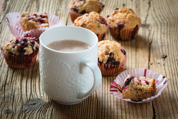 Cup cocoa with milk and homemade black berry muffins