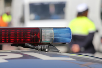 Red and blue siren police car during the roadblock