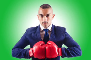 Handsome businessman with boxing gloves