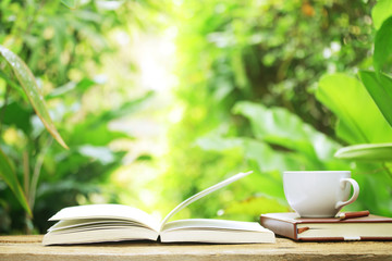 Notebook  and coffee on wooden table