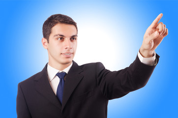 Young businessman pressing virtual buttons