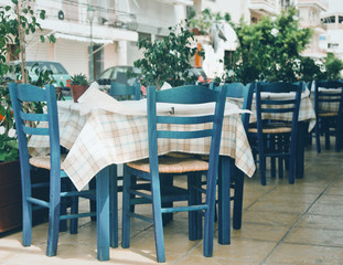 Fototapeta na wymiar Blue chairs on a greek cafe on Zakinthos