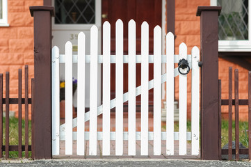 picket fence gate at the front of a home