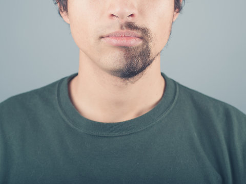 Young man with half shaved beard