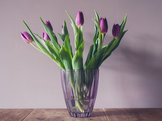 Vase with purple tulips