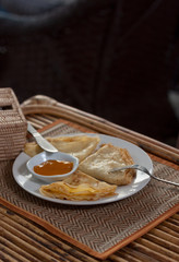 Crepes with mango jam on mat