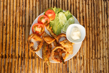 Vegetable tempura snack on plate on bamboo table