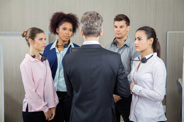 Manager Discussing With Serious Employees