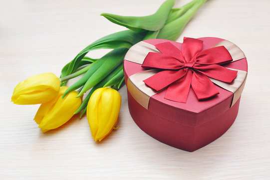 yellow tulips and beautiful gift in the form of heart