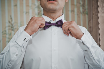 The man dresses a tie - a butterfly 2020.