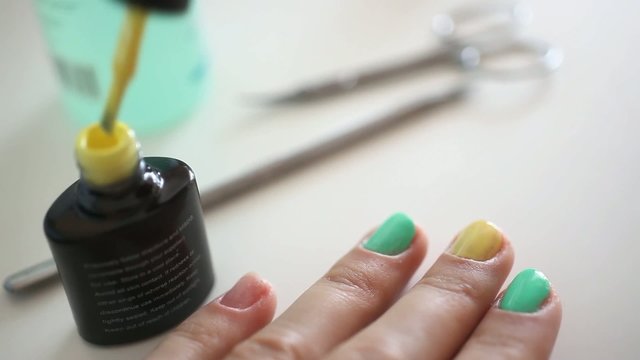 Manicurist doing spring manicure for woman in beauty salon