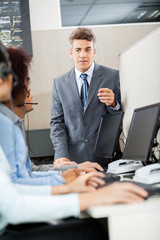 Manager Discussing With Customer Service Representatives