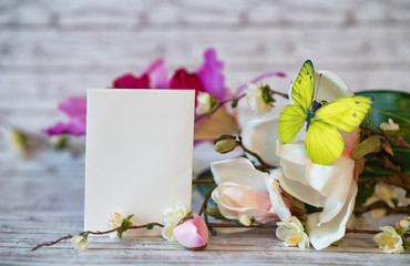 Blank White Card Leaning on Flowers with Butterfly