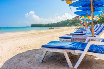 Beach umbrellas and sunbathe seats on Phuket sand beach
