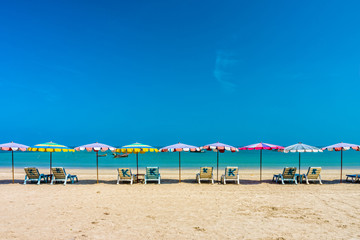 Beach umbrellas and sunbathe seats on Phuket sand beach