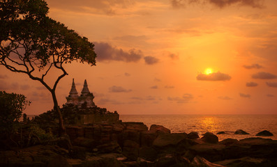 Beautiful sunset over the island beach with temple silhouette