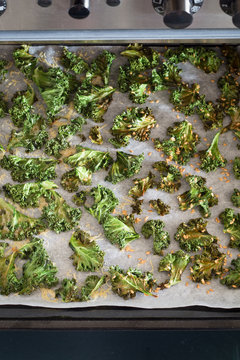 Curly Kale Chips with Cheese and Flax Seeds on the Baking Sheet